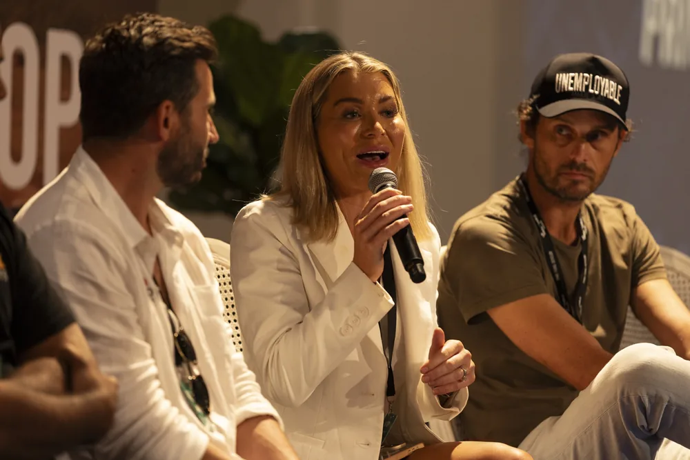 A panel answering questions from the floor, microphone in hand